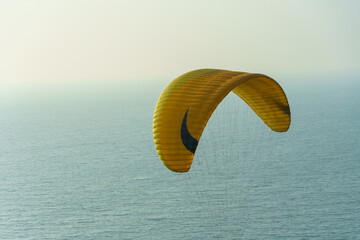 Paragliding in the sky over the sea. The concept of flying with a parachute. Close-up of a...