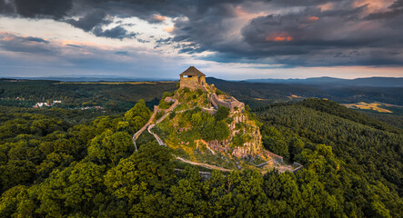 Salgotarjan, Hungary - Aerial panoramic view of Salgo Castle (Salgo vara) in Nograd county with dark clouds above at sunset on a sunny summer afternoon - obrazy, fototapety, plakaty