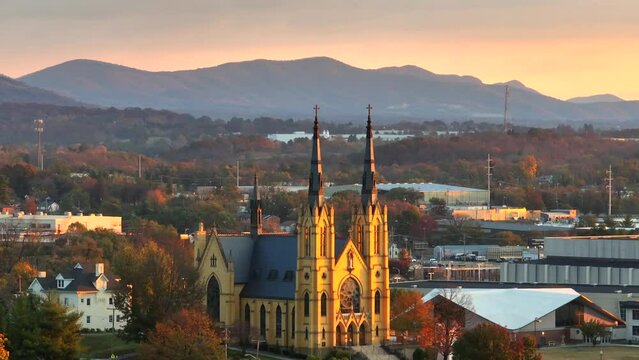 Catholic Church in golden hour light in Roanoke Virginia in autumn. Aerial view of Basilica of Saint Andrew.