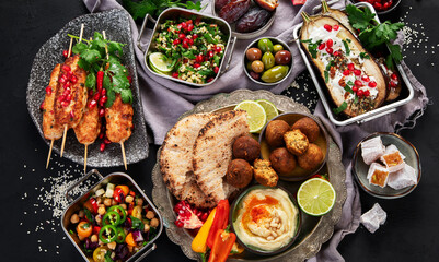 Middle eastern or Arabic different dishes on black background. Tasty traditional food concept