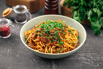 Portion of appetizing spaghetti bolognese with herbs