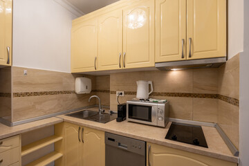 Kitchen interior with appliances in rental apartment