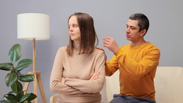 Family Crisis. Relationship Problem. Break Up And Divorce. Husband Asking Forgiveness Making Peace With Offended Annoyed Wife After Quarrel Or Cheating Young Woman Ignoring Man Not Talking