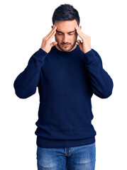 Young handsome man wearing casual clothes with hand on head for pain in head because stress. suffering migraine.