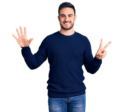 Young handsome man wearing casual clothes showing and pointing up with fingers number seven while smiling confident and happy.