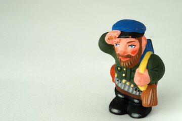 Funny figurines made of handmade ceramics. Man, hunter. Close-up.