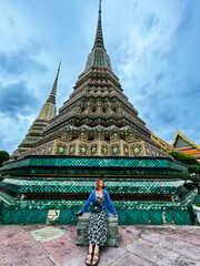 Naklejka premium Pictures of women sitting inside Wat Phra Kaew in Bangkok, Thailand. Beautiful landmark of Thailand