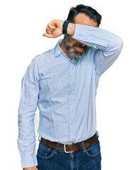 Middle aged man with beard wearing business shirt covering eyes with arm smiling cheerful and funny. blind concept.