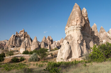 volcanic rock formations in Red Valley with carved tuff cliffs used as a church, Cappadocia, Turkey