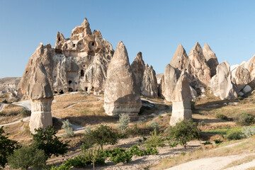 fairy chimneys and volcanic cliffs with carved dove houses in the background  in Rose Valley, Cappadocia, Turkey
