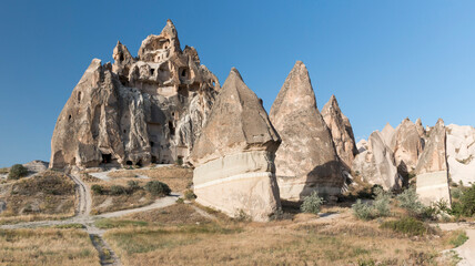 Fototapeta na wymiar volcanic cliffs with carved dove houses and fairy chimneys in Rose Valley, Cappadocia, Turkey