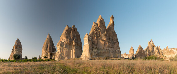 panorama view over Fairy Chimneys, special volcanic rock formation lit by evening lights at Red...