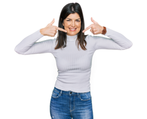 Beautiful brunette woman wearing casual clothes smiling cheerful showing and pointing with fingers teeth and mouth. dental health concept.