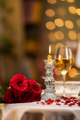 Vertical shot of valentines day dining table arrangements for couple at restaurant with flowers - concept of wedding anniversary, romantic evening and preparation