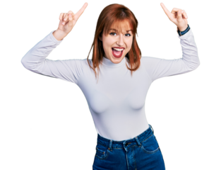 Redhead young woman wearing casual turtleneck sweater smiling amazed and surprised and pointing up with fingers and raised arms.