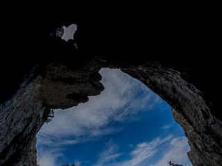 Mystical, dark and extraordinary cave with a hole in the ceiling