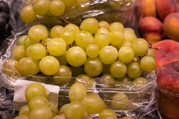 Cluster of grapes on a plastic tub in a marketplace