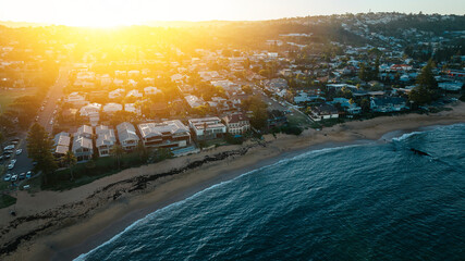 Aerial view during golden hour at one of Sydney's northern beaches coastal suburbs.