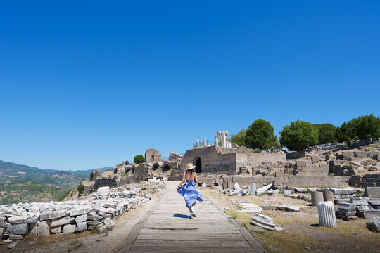 Lifestyle, Asian woman tourist take a holiday for travel in summer at Acropolis of Pergamon Ancient Greek City, Landmark of Tourism Turkiye, Izmir, Turkey. She is walking and enjoy relax vacation.
