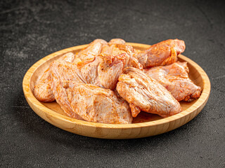 Raw marinated chicken wings on a plate