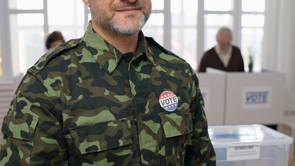 A soldier in a military uniform voting at the polling place, fulfilling his civic duty on elections...