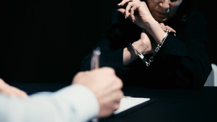 A distraught woman in handcuffs is denying involvement in the crime during a police interrogation
