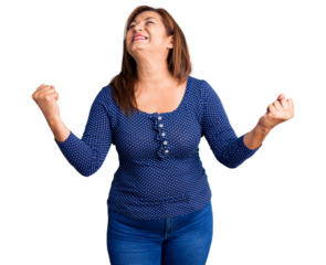 Middle age latin woman wearing casual clothes very happy and excited doing winner gesture with arms raised, smiling and screaming for success. celebration concept.