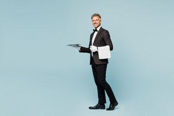 Full body side view adult barista male waiter butler man wear shirt black suit bow tie uniform...