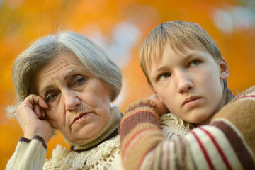 Sad Grandmother with boy in the park