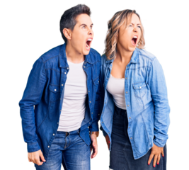 Couple of women wearing casual clothes angry and mad screaming frustrated and furious, shouting with anger. rage and aggressive concept.