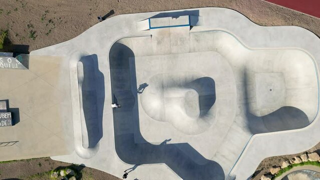 A bird's-eye view of a skateboard park in Parque das Gera&ccedil;&otilde;es in Lisbon, Portugal. The park is located in the heart of the city, and it is a popular spot for skateboarders of all ages.