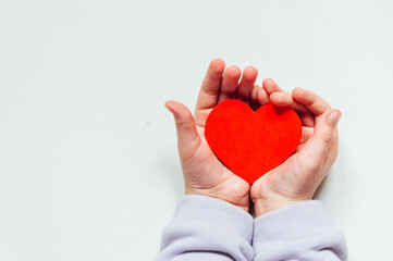 Fototapeta premium A red heart in a child's hand. High quality photo
