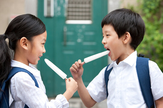 Happy Chinese children with popsicles