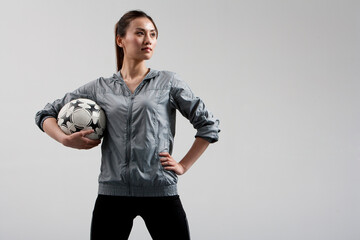 Determined Woman Carrying a Soccer Ball