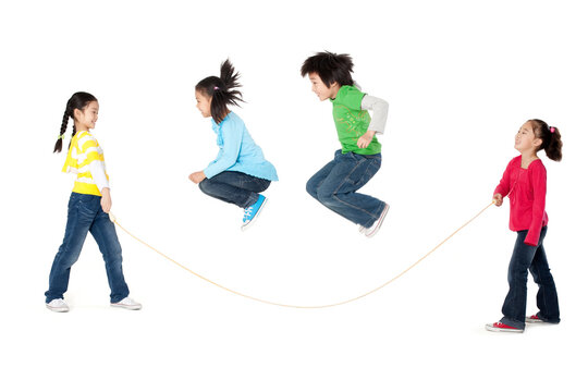 A group of friends play jump rope together