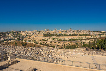 Panoramic view of Jerusalem view from the Mount of Olives featuring a Jewish cemetery and the Old City with the Temple Mount and the Dome of the Rock