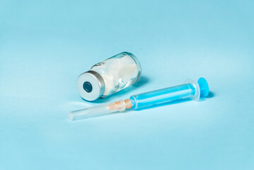 Syringe and needle with glass medical ampoule vials for injection. Medicine is dry white drug...