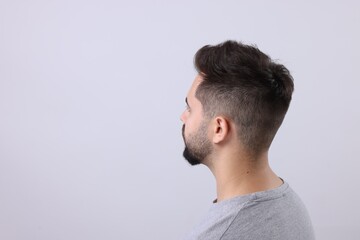 Fototapeta premium Man with healthy hair on light grey background, space for text