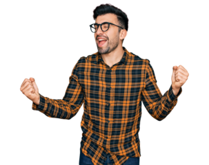 Hispanic man with beard wearing casual clothes and glasses very happy and excited doing winner gesture with arms raised, smiling and screaming for success. celebration concept.