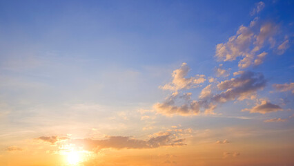 Sunrise sky with yellow sunlight and clouds on horizon blue sky background in the morning