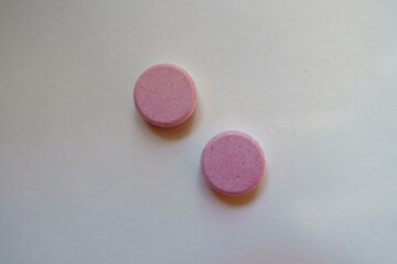 2 big pink oral probiotic tablets from above