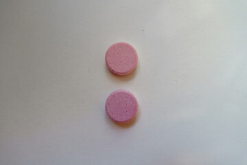 View of two big pink oral probiotic tablets from above