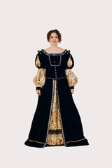 Portrait of a young aristocratic woman dressed in a medieval dress on white background. Front view