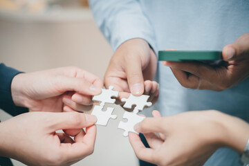 business strategy ideas Business team planning a strategic meeting Assembling jigsaw pieces, using jigsaw puzzles, showing solutions for business people, teamwork.	