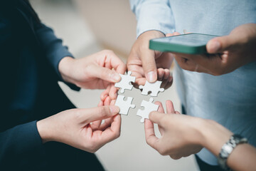 business strategy ideas Business team planning a strategic meeting Assembling jigsaw pieces, using jigsaw puzzles, showing solutions for business people, teamwork.	