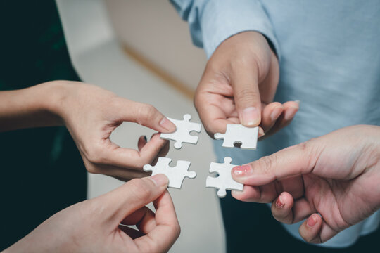 business strategy ideas Business team planning a strategic meeting Assembling jigsaw pieces, using jigsaw puzzles, showing solutions for business people, teamwork.	