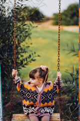 child on swing at the playground 