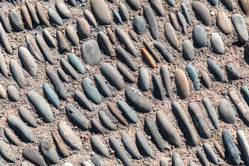 Pebble road as an abstract background. Texture