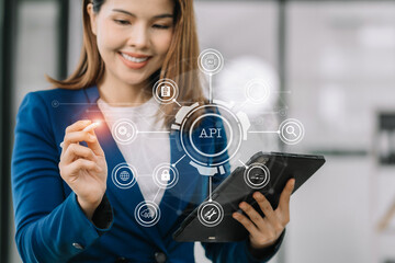 Modern technology and networking concept, woman using tablet with virtual screen API icon Software...