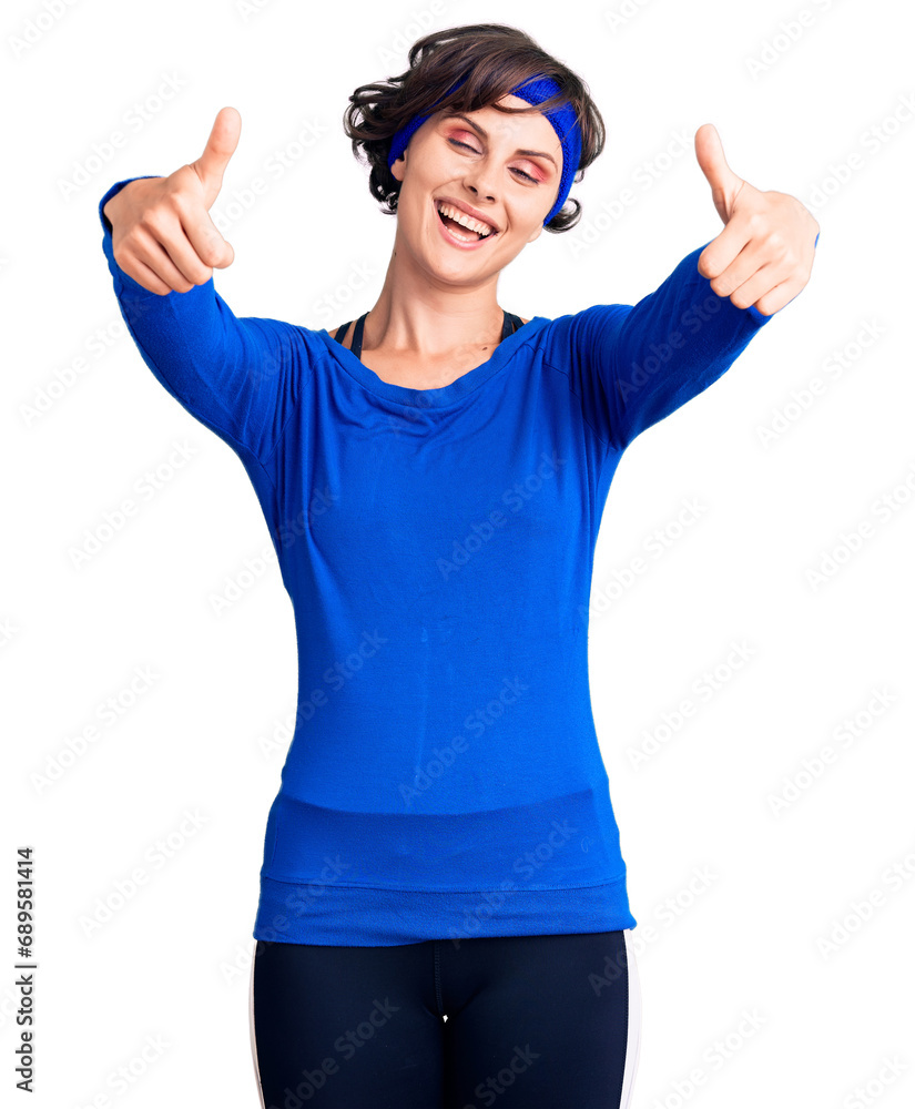 Sticker beautiful young woman with short hair wearing training workout clothes approving doing positive gest